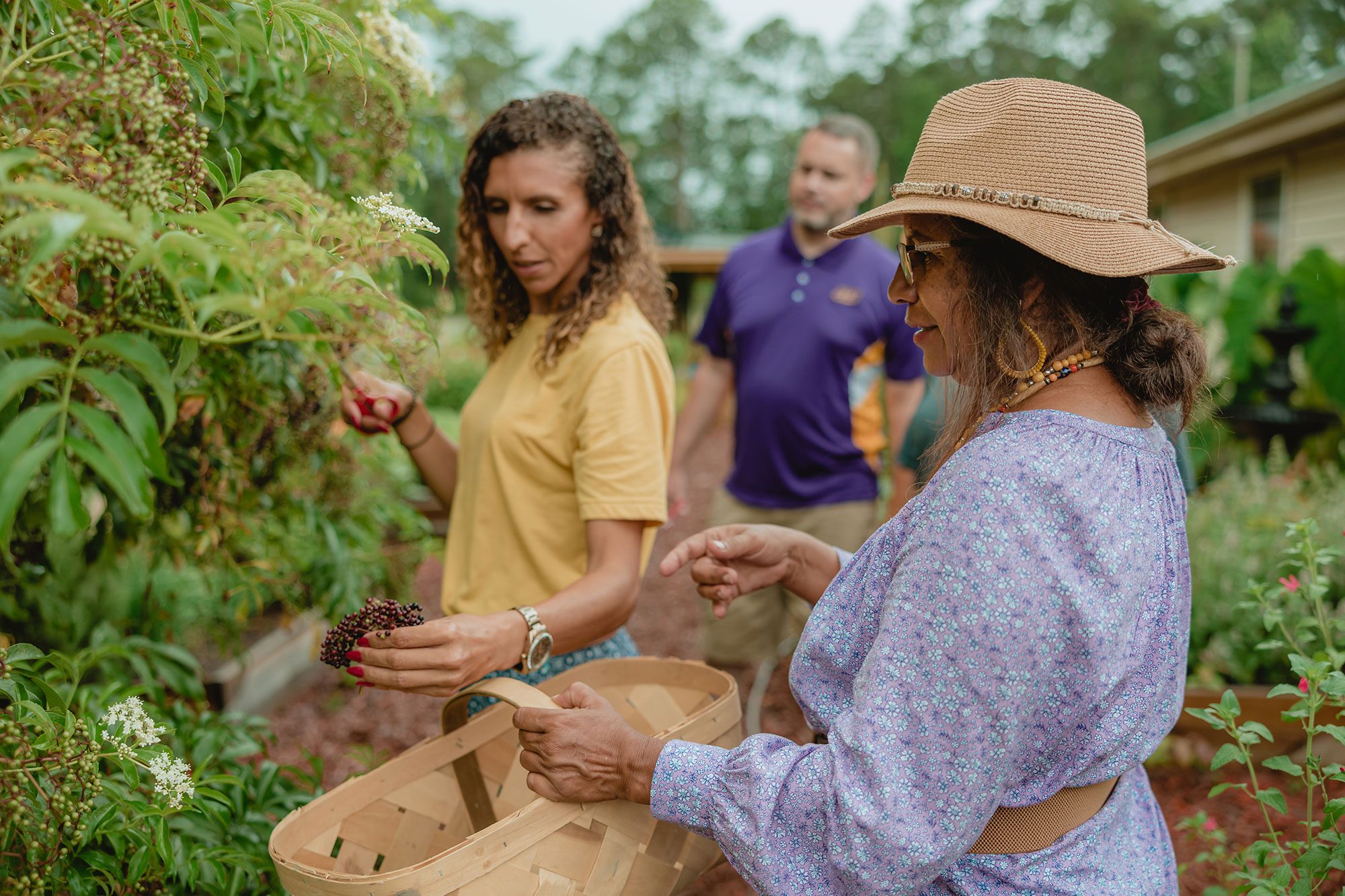 Darlene Graham picking vegetables with members of her Native American tribe.